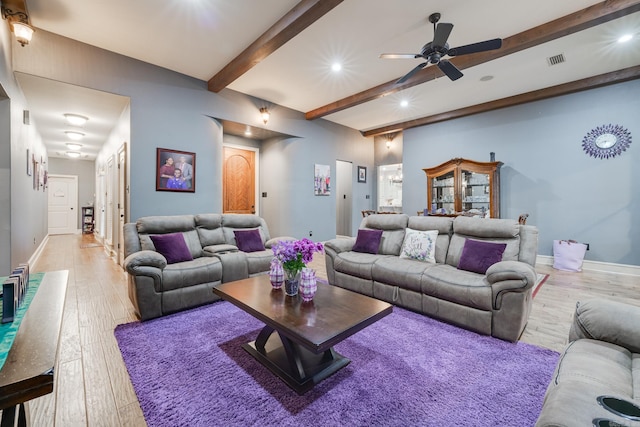 living room with ceiling fan, beam ceiling, and light hardwood / wood-style flooring