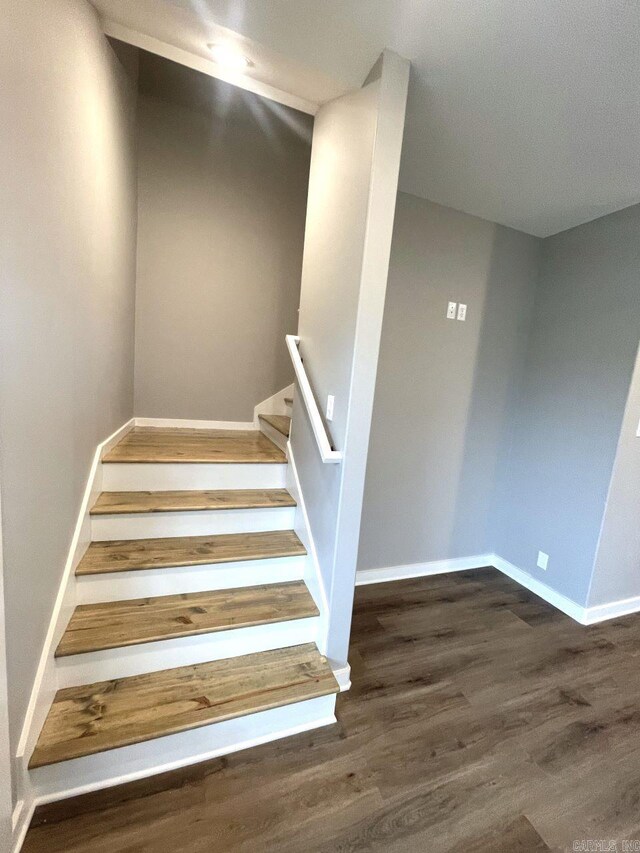 stairs with wood-type flooring