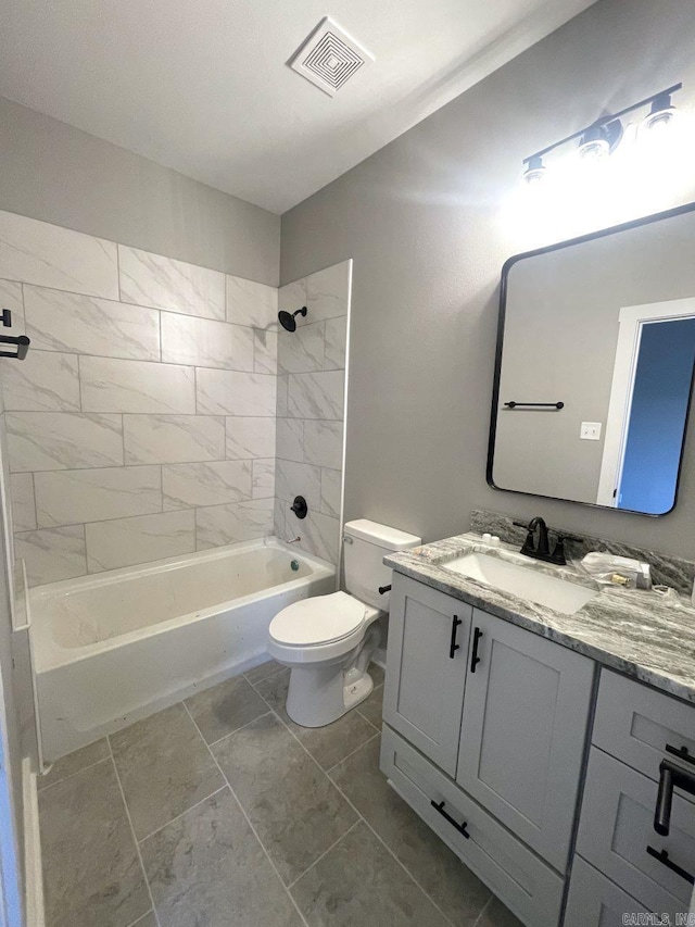 full bathroom featuring vanity, tiled shower / bath combo, and toilet