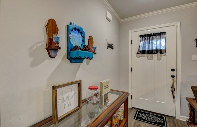 entryway with hardwood / wood-style floors and crown molding