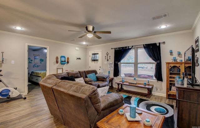 living room with ceiling fan, wood-type flooring, and ornamental molding