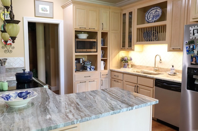 kitchen with light brown cabinets, sink, tasteful backsplash, light stone counters, and stainless steel appliances