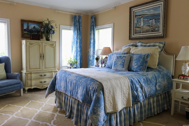 carpeted bedroom with ornamental molding and multiple windows