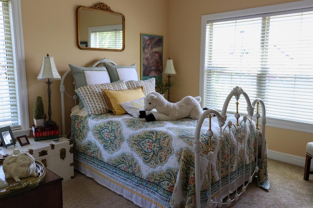 bedroom with multiple windows and carpet