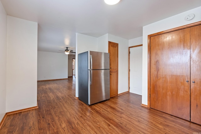 kitchen with wood-type flooring, stainless steel refrigerator, and ceiling fan