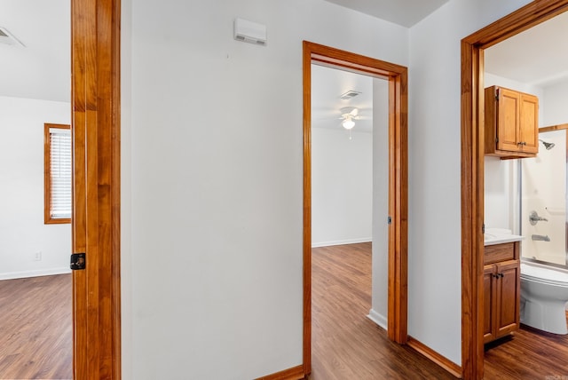 hallway with hardwood / wood-style floors