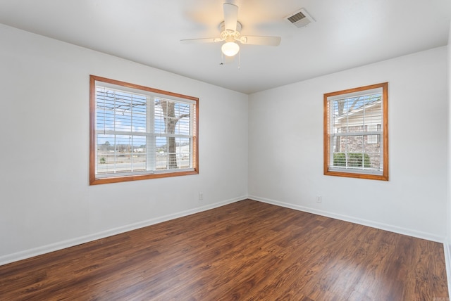 unfurnished room with ceiling fan and dark hardwood / wood-style flooring