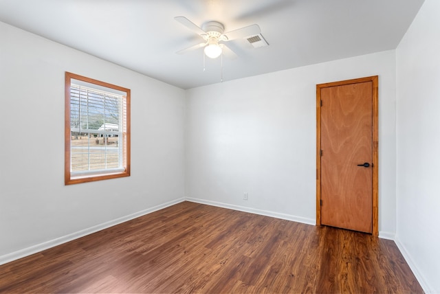 unfurnished room featuring dark hardwood / wood-style floors and ceiling fan