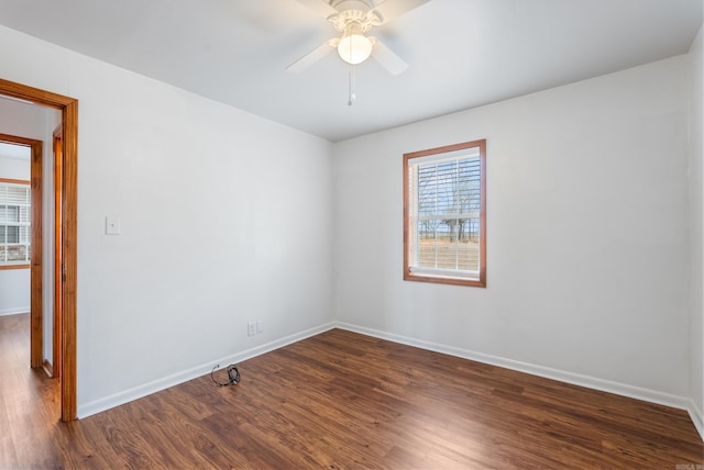 empty room featuring dark hardwood / wood-style flooring and ceiling fan