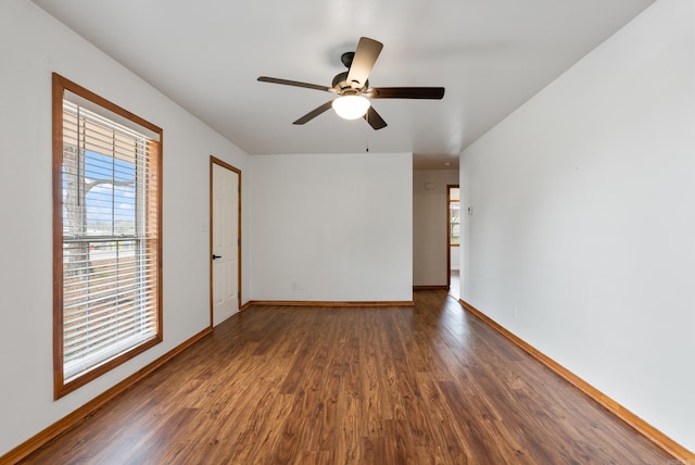 spare room featuring ceiling fan and dark hardwood / wood-style floors