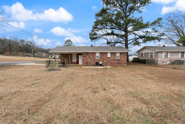 rear view of property featuring a lawn