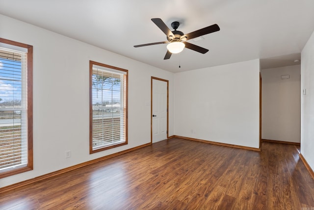 spare room featuring dark hardwood / wood-style floors and ceiling fan