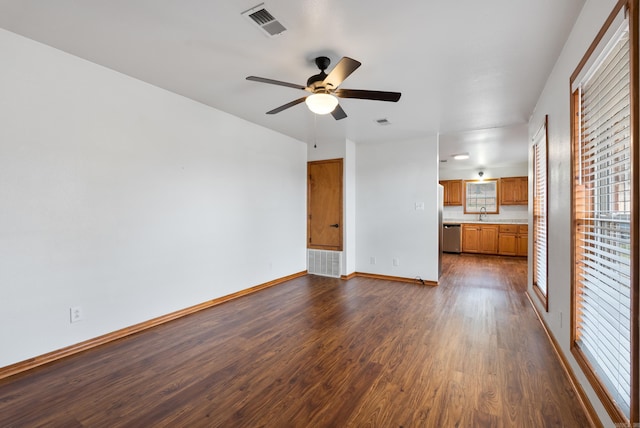 unfurnished living room with dark hardwood / wood-style floors, sink, and ceiling fan