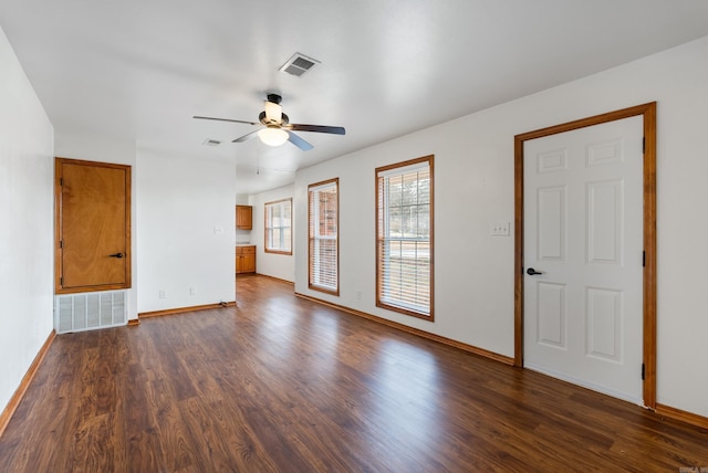 unfurnished room with dark wood-type flooring and ceiling fan