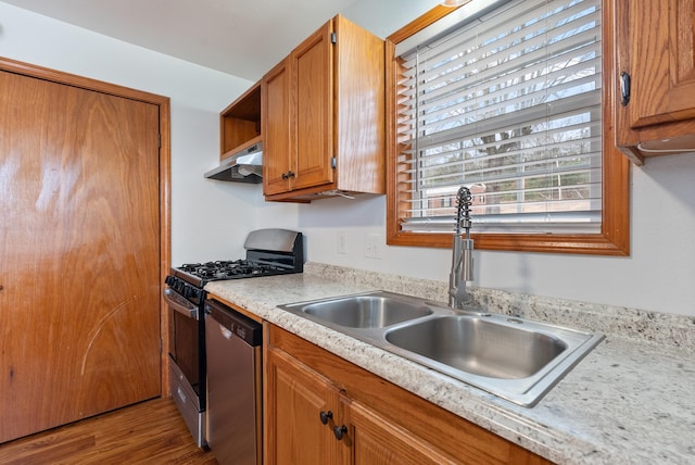 kitchen with appliances with stainless steel finishes, dark hardwood / wood-style flooring, and sink