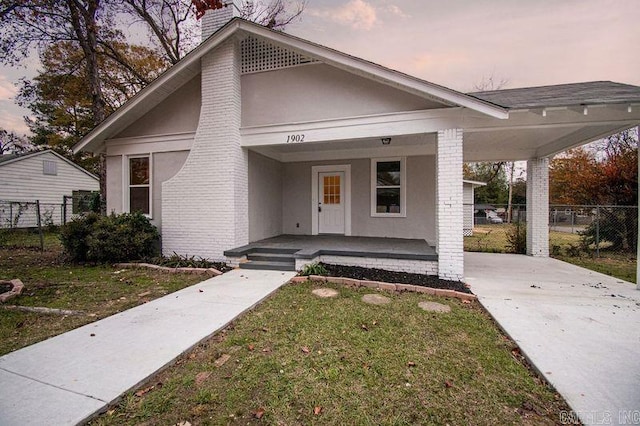 view of front of house with a yard and a porch