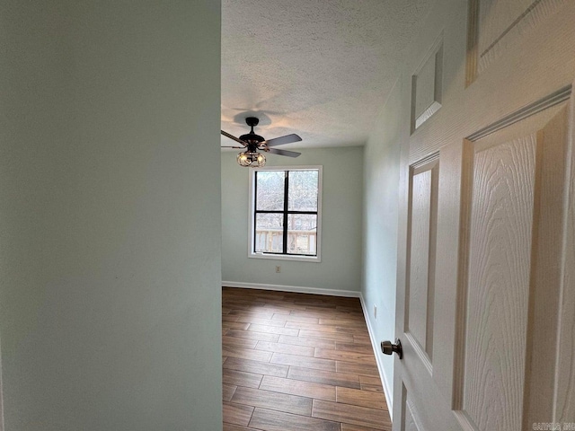 spare room with a textured ceiling and ceiling fan