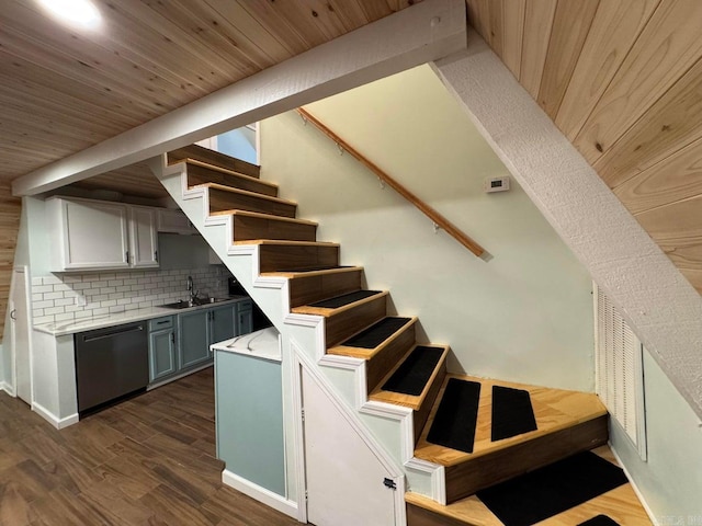 staircase featuring hardwood / wood-style flooring and sink