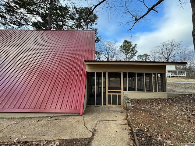 view of home's exterior with a sunroom