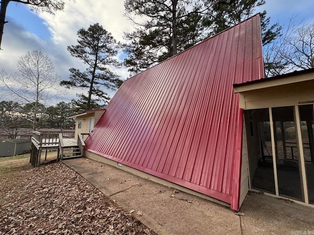 view of home's exterior with a sunroom and a deck