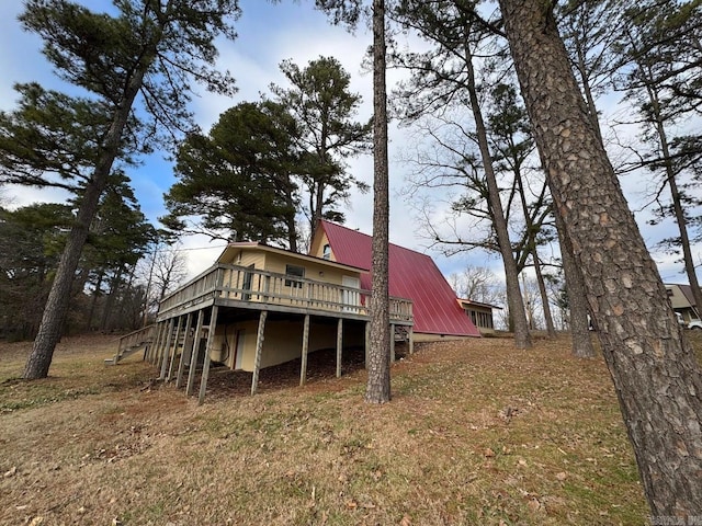 rear view of house featuring a deck