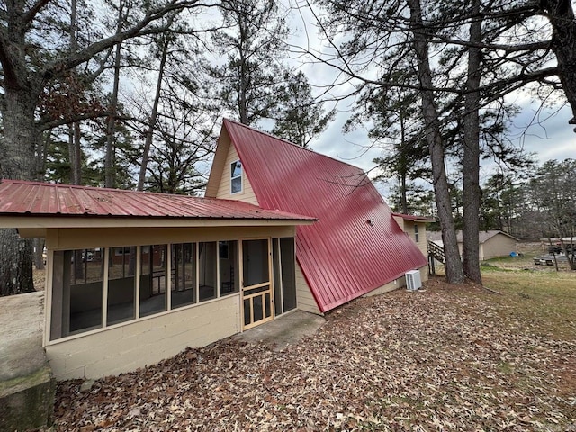 rear view of house featuring a sunroom