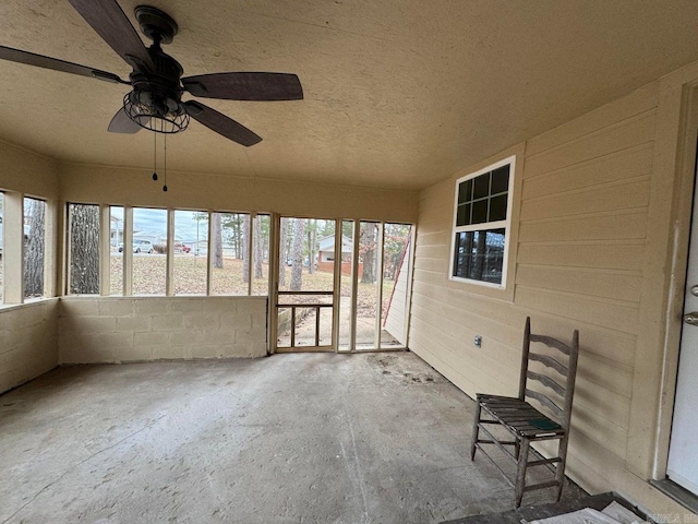 unfurnished sunroom with a water view, plenty of natural light, and ceiling fan