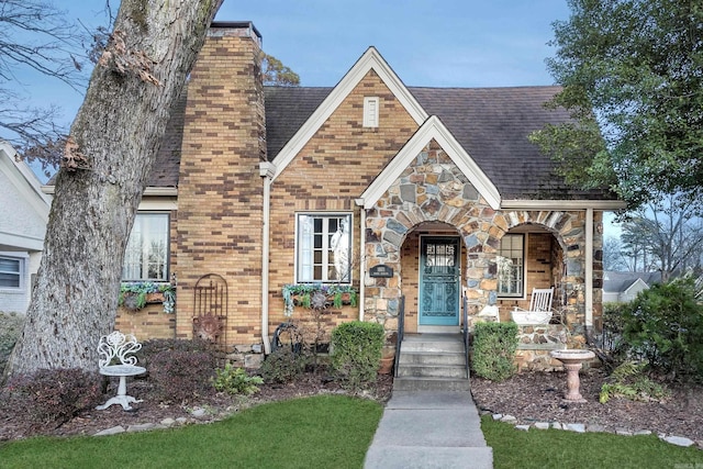 tudor home featuring covered porch