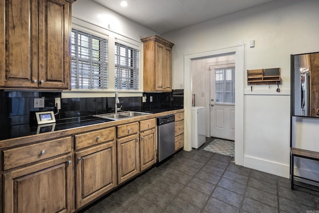 kitchen with tasteful backsplash, stainless steel dishwasher, a healthy amount of sunlight, and sink