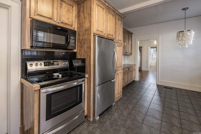 kitchen featuring stainless steel appliances and dark tile patterned floors