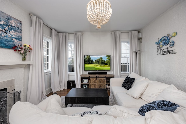 living room featuring a healthy amount of sunlight, a chandelier, and hardwood / wood-style flooring