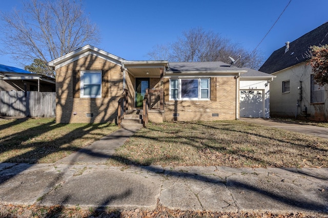 view of front of home with a front yard and a garage