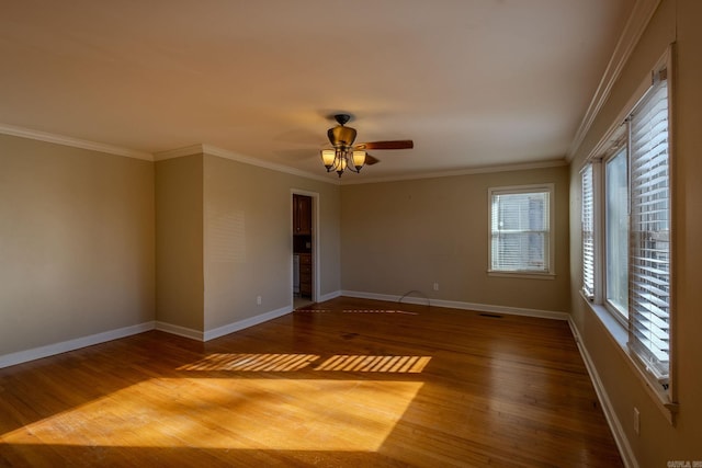 empty room with hardwood / wood-style floors, plenty of natural light, and ceiling fan