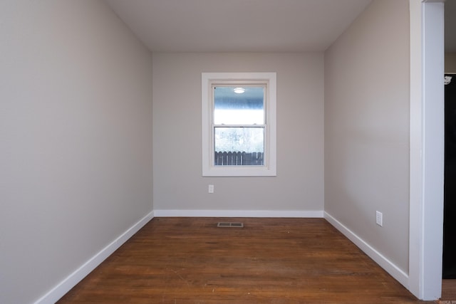 unfurnished room with dark hardwood / wood-style flooring