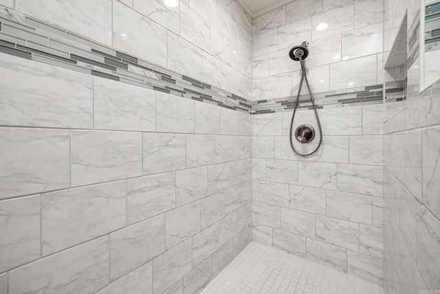 bathroom with a tile shower