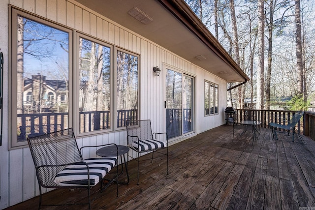 wooden deck with a grill