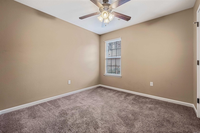 carpeted spare room featuring ceiling fan