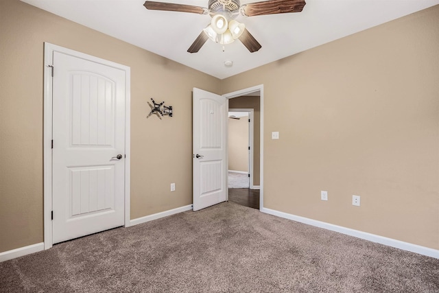 unfurnished bedroom with ceiling fan and carpet