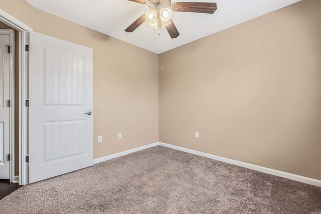 carpeted spare room with ceiling fan