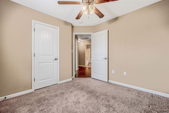 unfurnished bedroom with dark colored carpet and ceiling fan