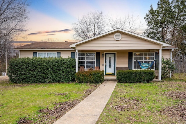 view of front of home featuring a porch and a lawn