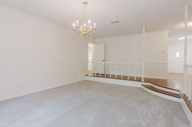 empty room featuring a chandelier, carpet floors, and ornamental molding