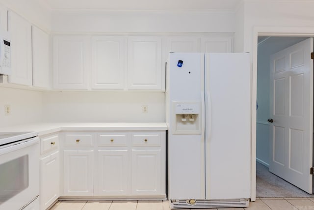 kitchen with white cabinetry, stove, white fridge with ice dispenser, and light tile patterned floors