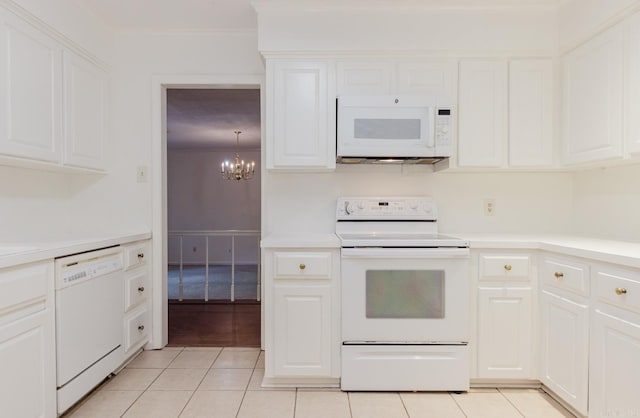 kitchen featuring white appliances, white cabinets, hanging light fixtures, light tile patterned floors, and a notable chandelier