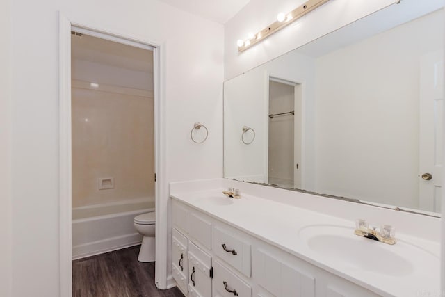 bathroom featuring hardwood / wood-style floors, vanity, and toilet