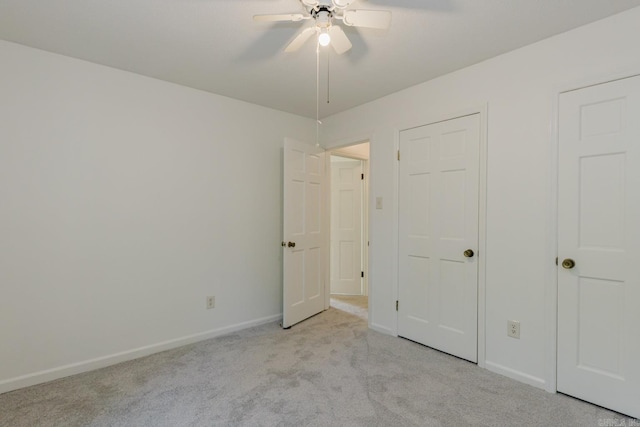 unfurnished bedroom with ceiling fan and light carpet