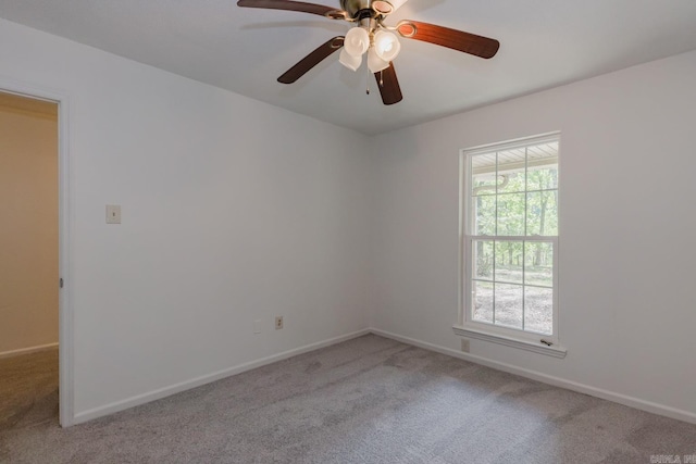 carpeted spare room with ceiling fan