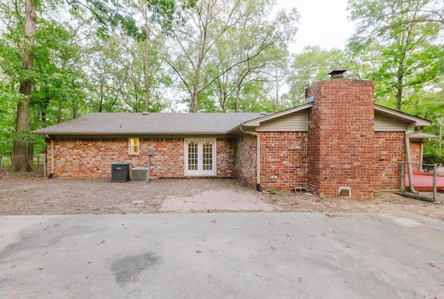 back of house with french doors and central AC