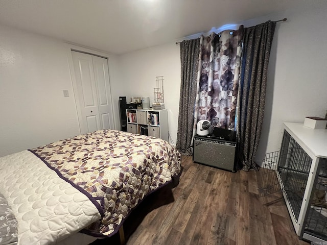 bedroom with dark wood-type flooring and a closet