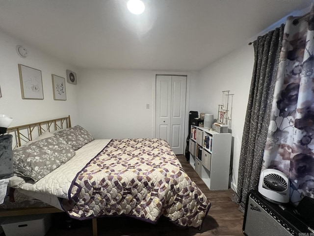 bedroom featuring dark wood-type flooring and a closet